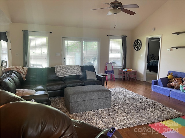 living room with vaulted ceiling, ceiling fan, and dark hardwood / wood-style flooring