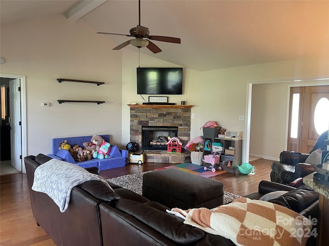 living room featuring vaulted ceiling with beams, a fireplace, hardwood / wood-style floors, and ceiling fan