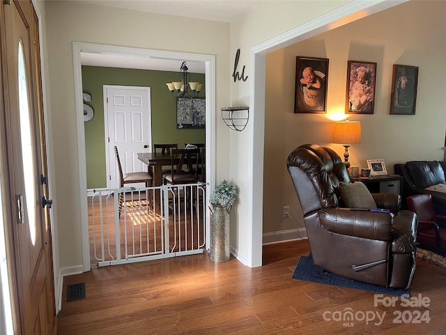 interior space with hardwood / wood-style flooring and a notable chandelier