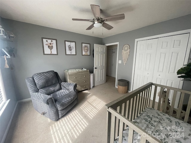 carpeted bedroom featuring ceiling fan and a closet