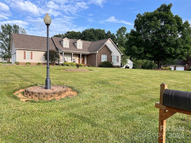 view of front facade featuring a front lawn and covered porch