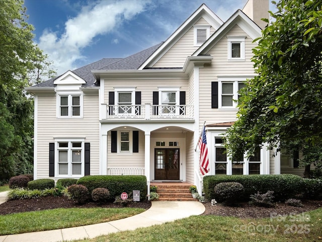 view of front facade featuring french doors and a balcony