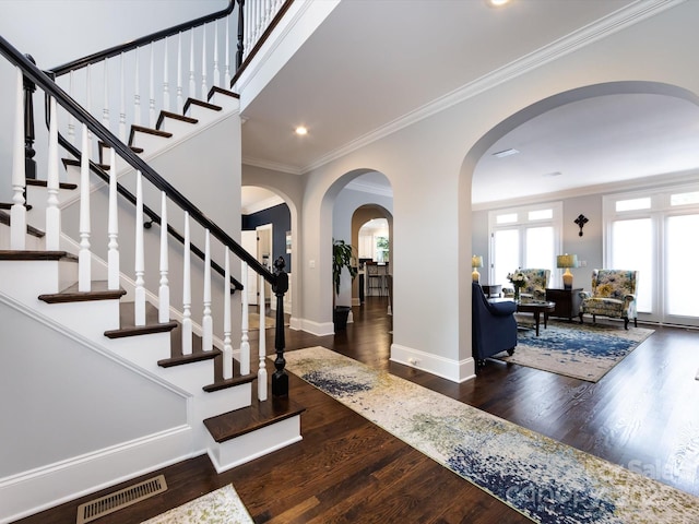 entryway featuring dark hardwood / wood-style flooring and crown molding