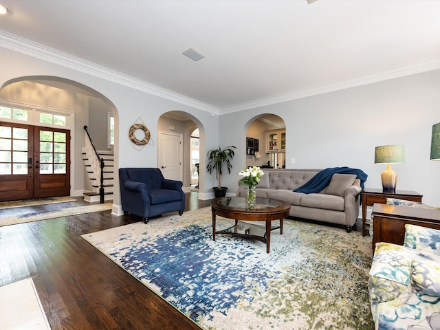 living room with crown molding, dark hardwood / wood-style floors, and french doors