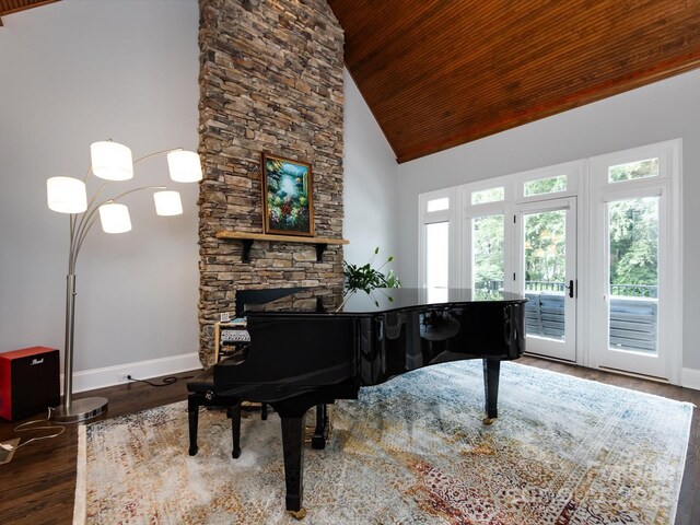 miscellaneous room with french doors, wood ceiling, high vaulted ceiling, a fireplace, and hardwood / wood-style floors