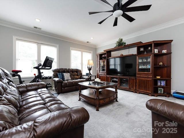 living room with crown molding, light colored carpet, and ceiling fan