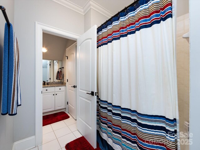 bathroom featuring vanity, tile patterned flooring, and ornamental molding