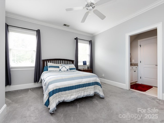 bedroom with crown molding, light carpet, ceiling fan, and ensuite bath