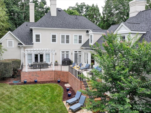 rear view of property featuring a patio, outdoor lounge area, a yard, and a pergola