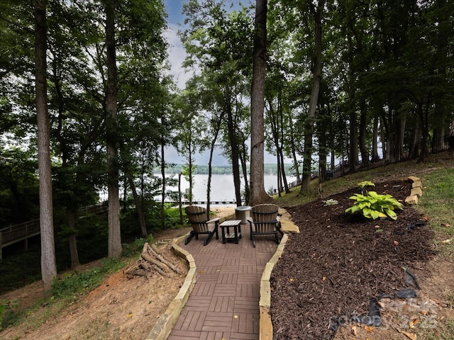 view of community with a water view and a patio area