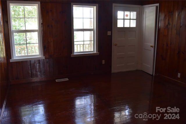 foyer with wood walls