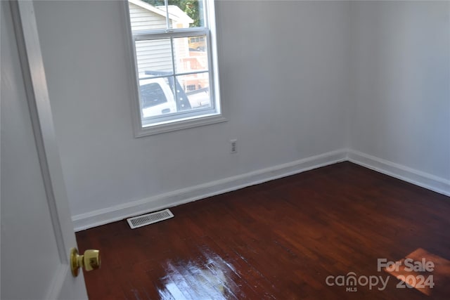 empty room featuring dark wood-type flooring