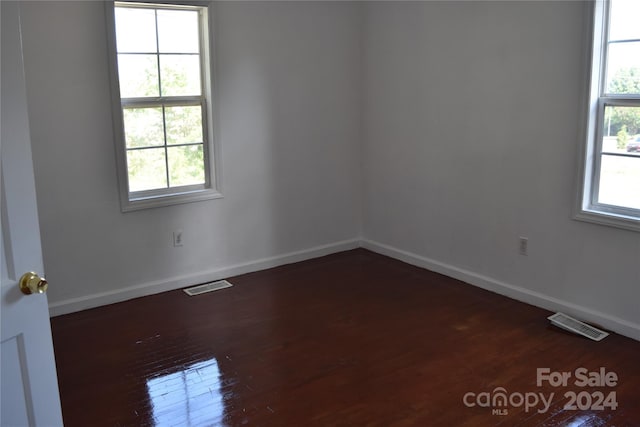 spare room featuring dark hardwood / wood-style flooring