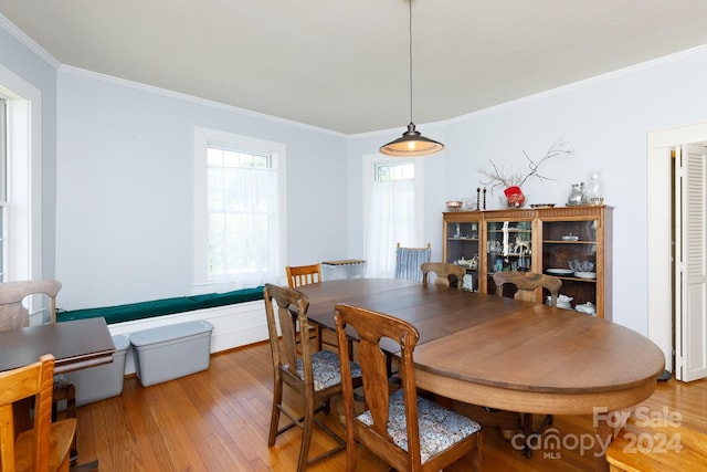 dining room featuring hardwood / wood-style floors and ornamental molding