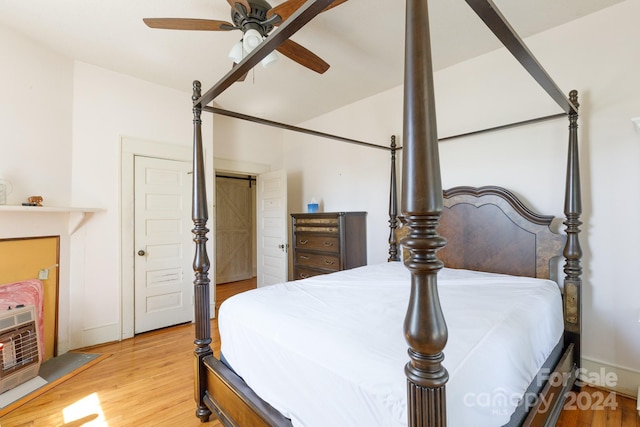 bedroom with ceiling fan and light hardwood / wood-style flooring