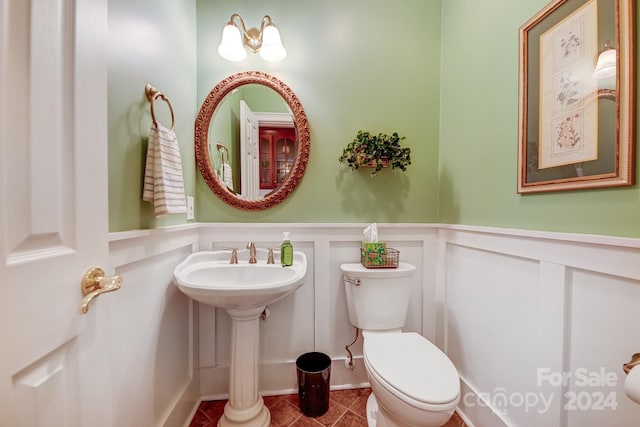 bathroom with sink, tile patterned flooring, and toilet