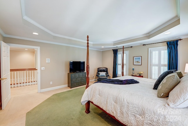 carpeted bedroom featuring a tray ceiling and crown molding