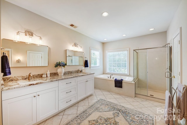 bathroom with tile patterned floors, vanity, and plus walk in shower