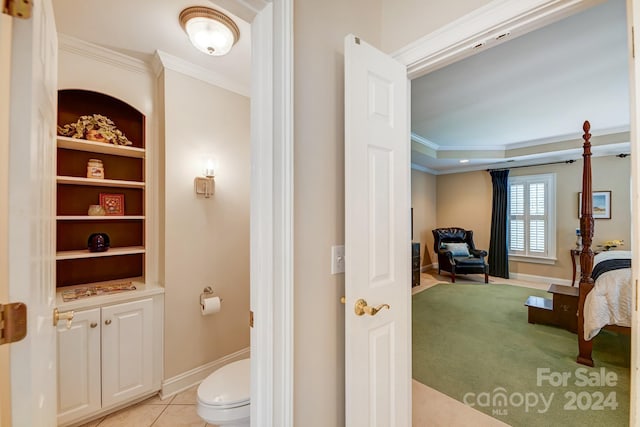 bathroom with tile patterned floors, toilet, and crown molding