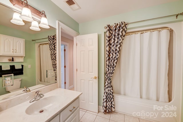 full bathroom featuring tile patterned flooring, shower / bath combination with curtain, toilet, and vanity