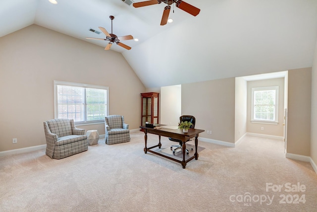 interior space with a wealth of natural light, ceiling fan, and light colored carpet