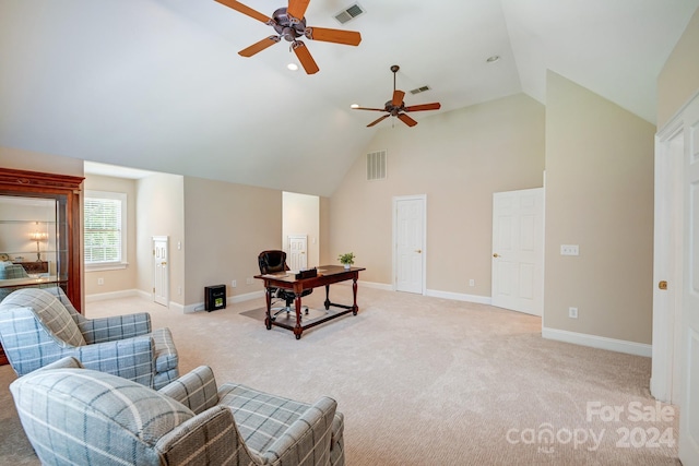 carpeted living room with ceiling fan and high vaulted ceiling