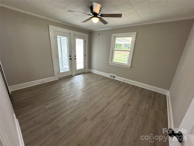 foyer entrance with french doors, ceiling fan, dark wood-type flooring, and crown molding