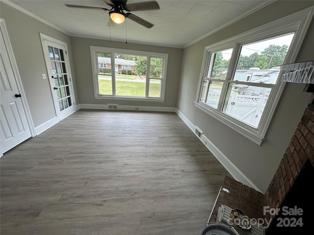 interior space with ceiling fan, hardwood / wood-style flooring, and ornamental molding