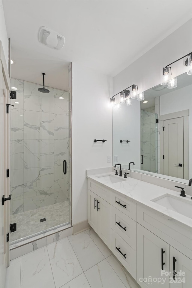 bathroom with marble finish floor, a sink, and a marble finish shower