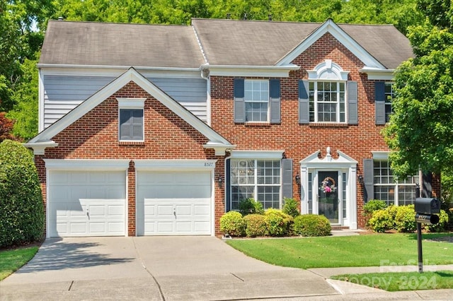 view of front of home with a garage and a front lawn