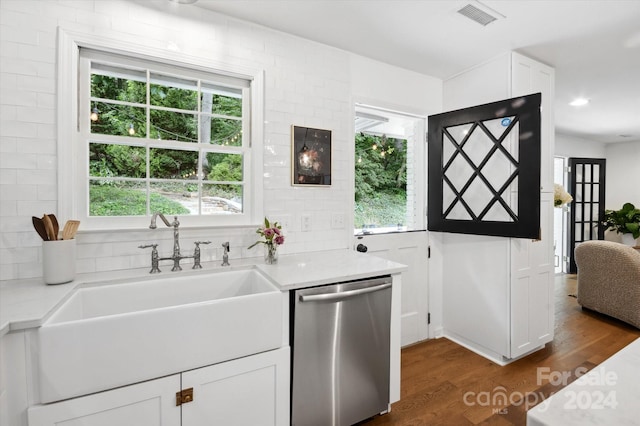 kitchen with sink, stainless steel dishwasher, dark hardwood / wood-style floors, and white cabinets