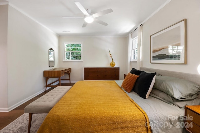 bedroom featuring crown molding, wood-type flooring, and ceiling fan