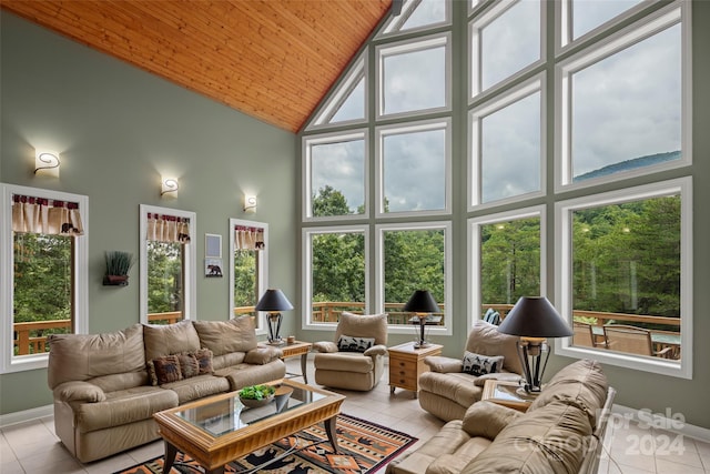 sunroom featuring vaulted ceiling and wood ceiling