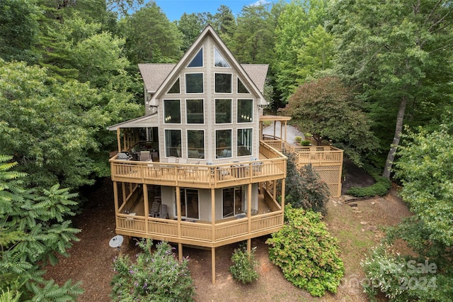 rear view of property with a wooden deck