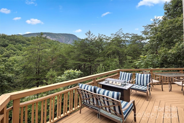 deck featuring a mountain view and a fire pit