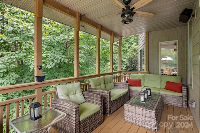 sunroom featuring ceiling fan and plenty of natural light