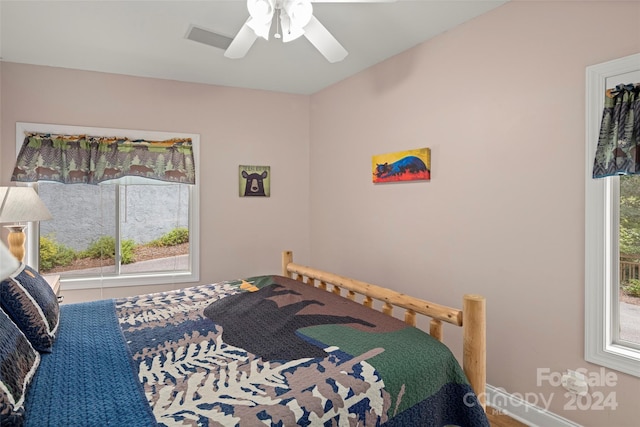 bedroom with multiple windows and ceiling fan