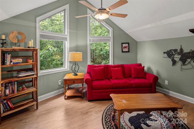 living room with ceiling fan, light wood-type flooring, and lofted ceiling