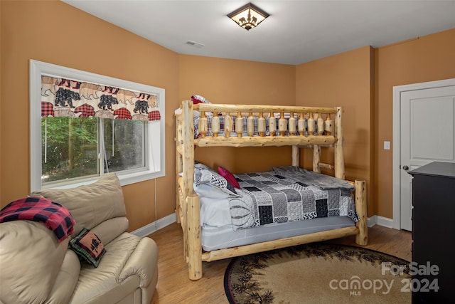 bedroom with hardwood / wood-style flooring