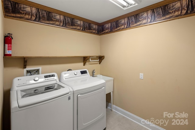 washroom with washing machine and dryer and light tile patterned floors