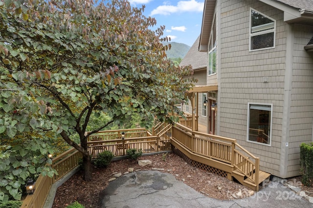 exterior space featuring a deck with mountain view and a patio