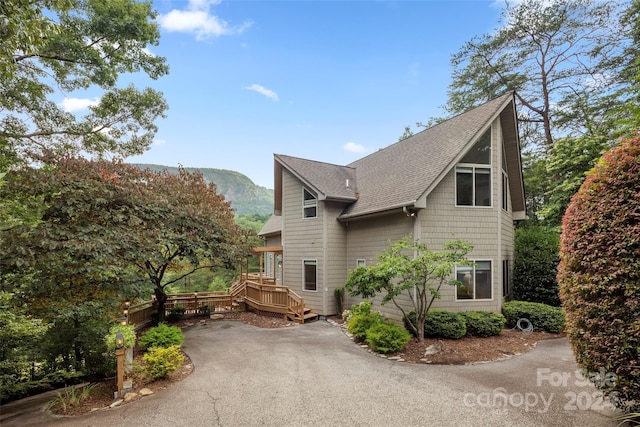 view of home's exterior with a deck with mountain view