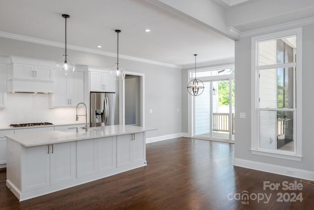 kitchen featuring white cabinetry, a kitchen island with sink, decorative light fixtures, and appliances with stainless steel finishes