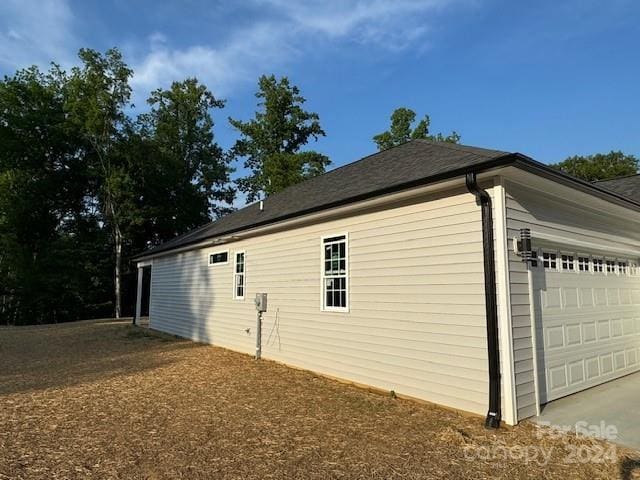 view of side of property with a garage