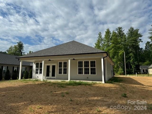 back of property with ceiling fan and french doors