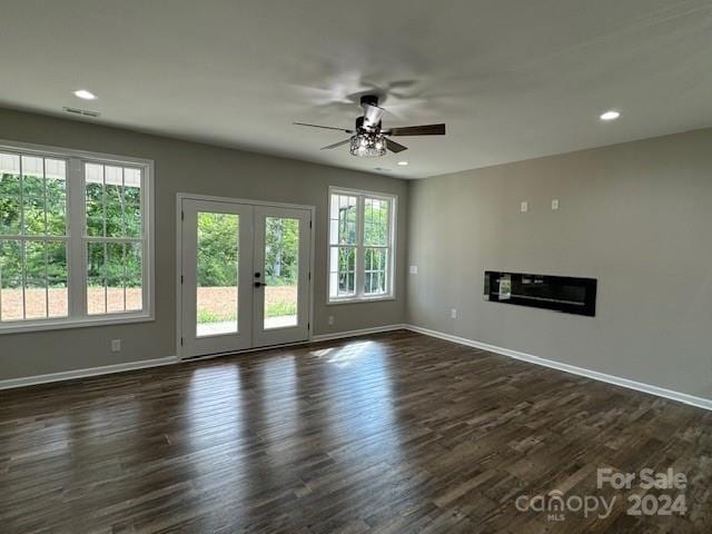 unfurnished living room featuring ceiling fan, french doors, and dark hardwood / wood-style floors