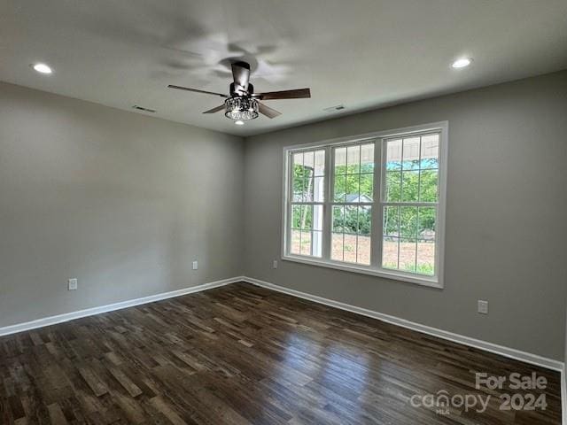 empty room with ceiling fan and dark hardwood / wood-style floors