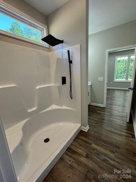 bathroom featuring a shower and wood-type flooring