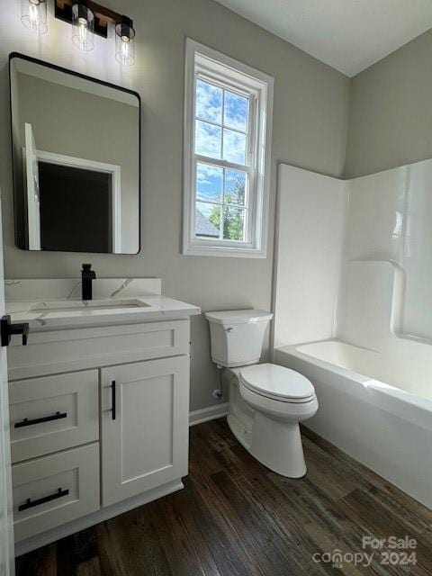 full bathroom with toilet, hardwood / wood-style floors, vanity, and bathtub / shower combination