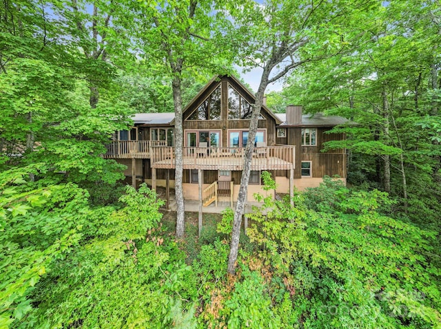 rear view of property with a wooden deck